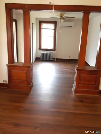 a view of room with window and wooden floor