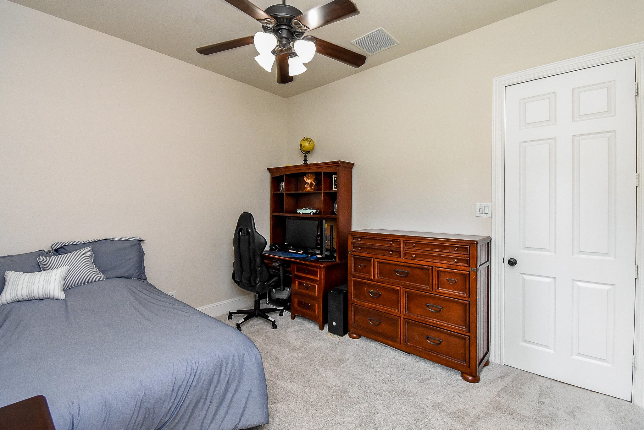 27427 Guthrie Ridge Lane Katy, TX 77494 - Photo 30 of 48 a bedroom with a bed and a chandelier