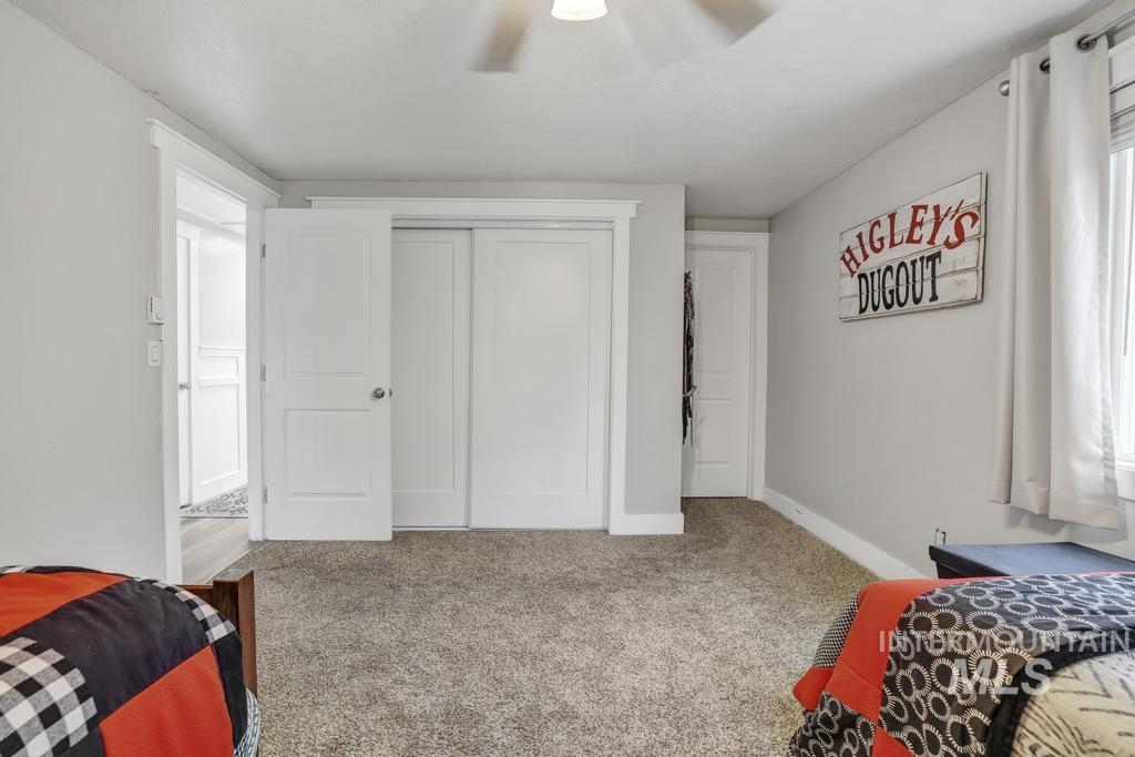 1785 River Road Buhl, ID 83316 - Photo 12 of 41 Bedroom featuring carpet, a closet, a ceiling fan, and multiple windows