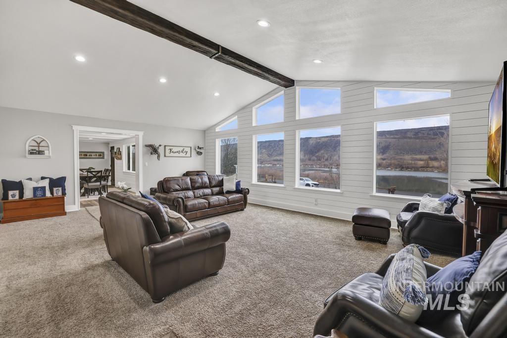 1785 River Road Buhl, ID 83316 - Photo 16 of 41 Living area with carpet, recessed lighting, and wooden walls