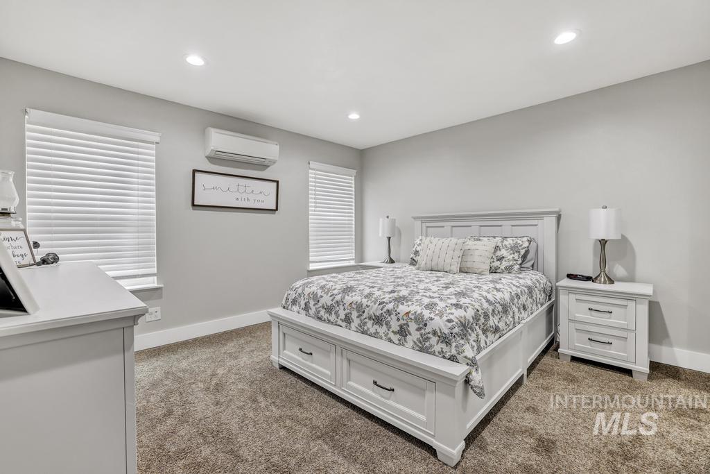 1785 River Road Buhl, ID 83316 - Photo 21 of 41 Bedroom featuring an AC wall unit, light colored carpet, and recessed lighting