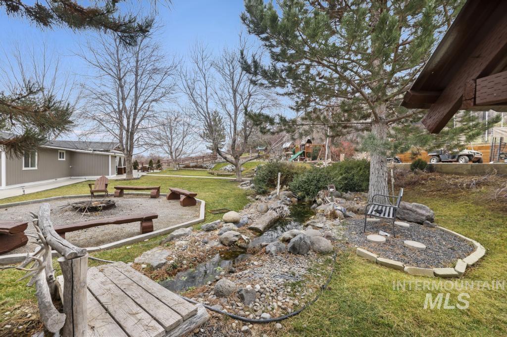 1785 River Road Buhl, ID 83316 - Photo 26 of 41 View of green lawn with a patio area and a playground