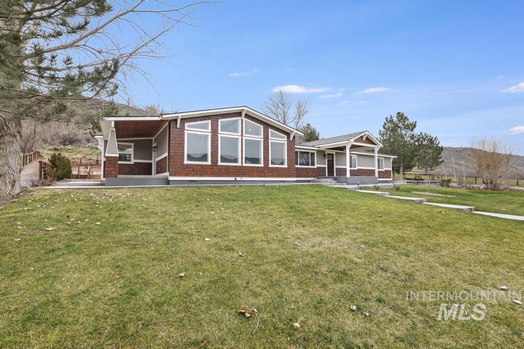 1785 River Road Buhl, ID 83316 - Photo 28 of 41 Rear view of house with a lawn and covered porch