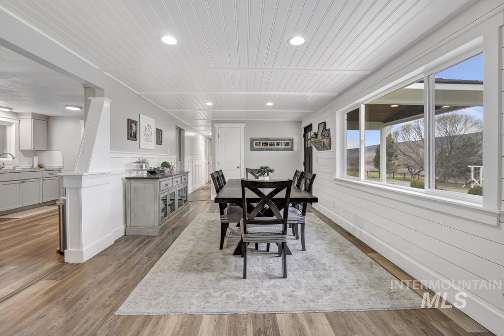 1785 River Road Buhl, ID 83316 - Photo 5 of 41 Dining space with light wood-style flooring, recessed lighting, and wainscoting