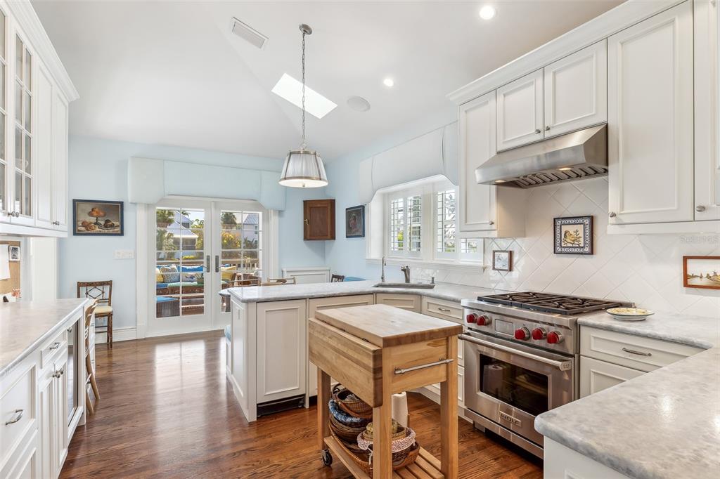 160 Sheep Shank Court Boca Grande, FL 33921 - Photo 11 of 36 a kitchen with a stove and a wooden floor