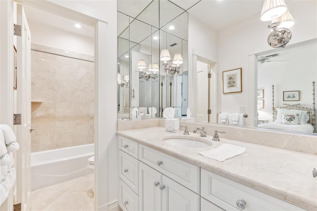 160 Sheep Shank Court Boca Grande, FL 33921 - Photo 21 of 36 a bathroom with a sink double vanity granite tub shower and a mirror