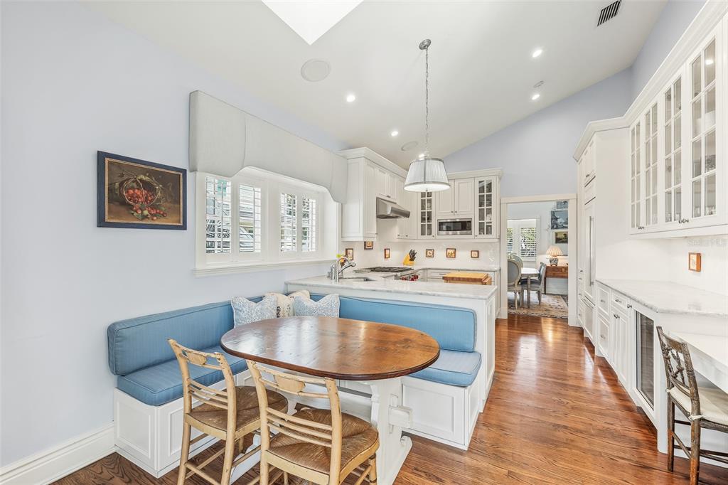 160 Sheep Shank Court Boca Grande, FL 33921 - Photo 10 of 36 a kitchen with a dining table chairs wooden floor and appliances