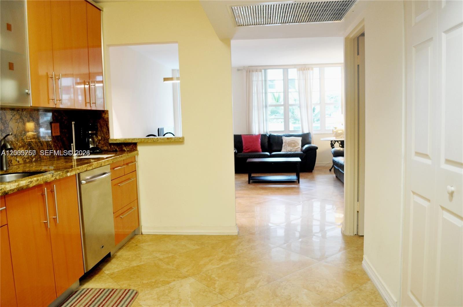 100 Lincoln Road, Unit 534 Miami Beach, FL 33139 - Photo 4 of 15 a view of a kitchen with kitchen island granite countertop a refrigerator stove and a sink