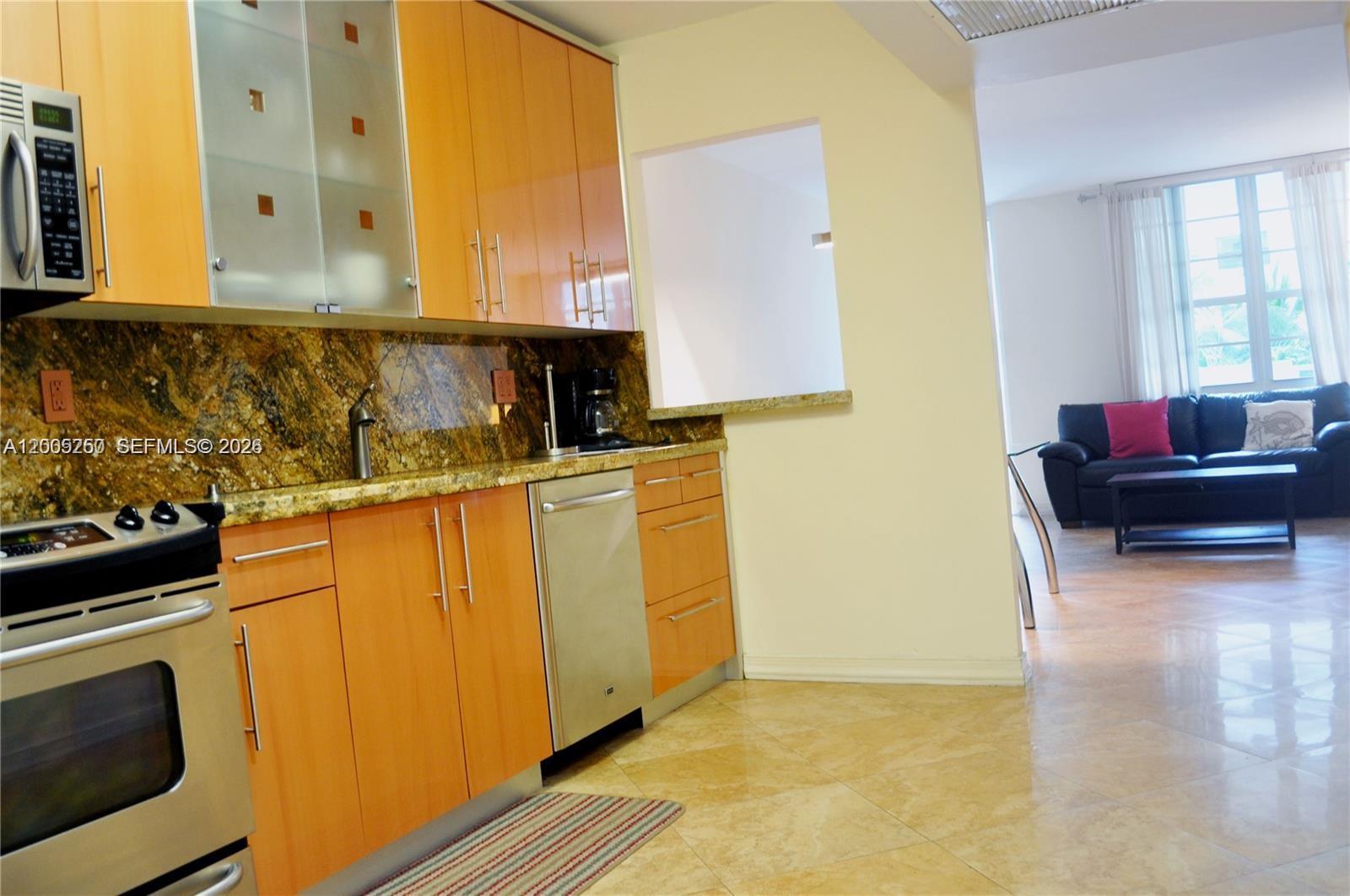 100 Lincoln Road, Unit 534 Miami Beach, FL 33139 - Photo 5 of 15 a kitchen with granite countertop a sink stove and cabinets
