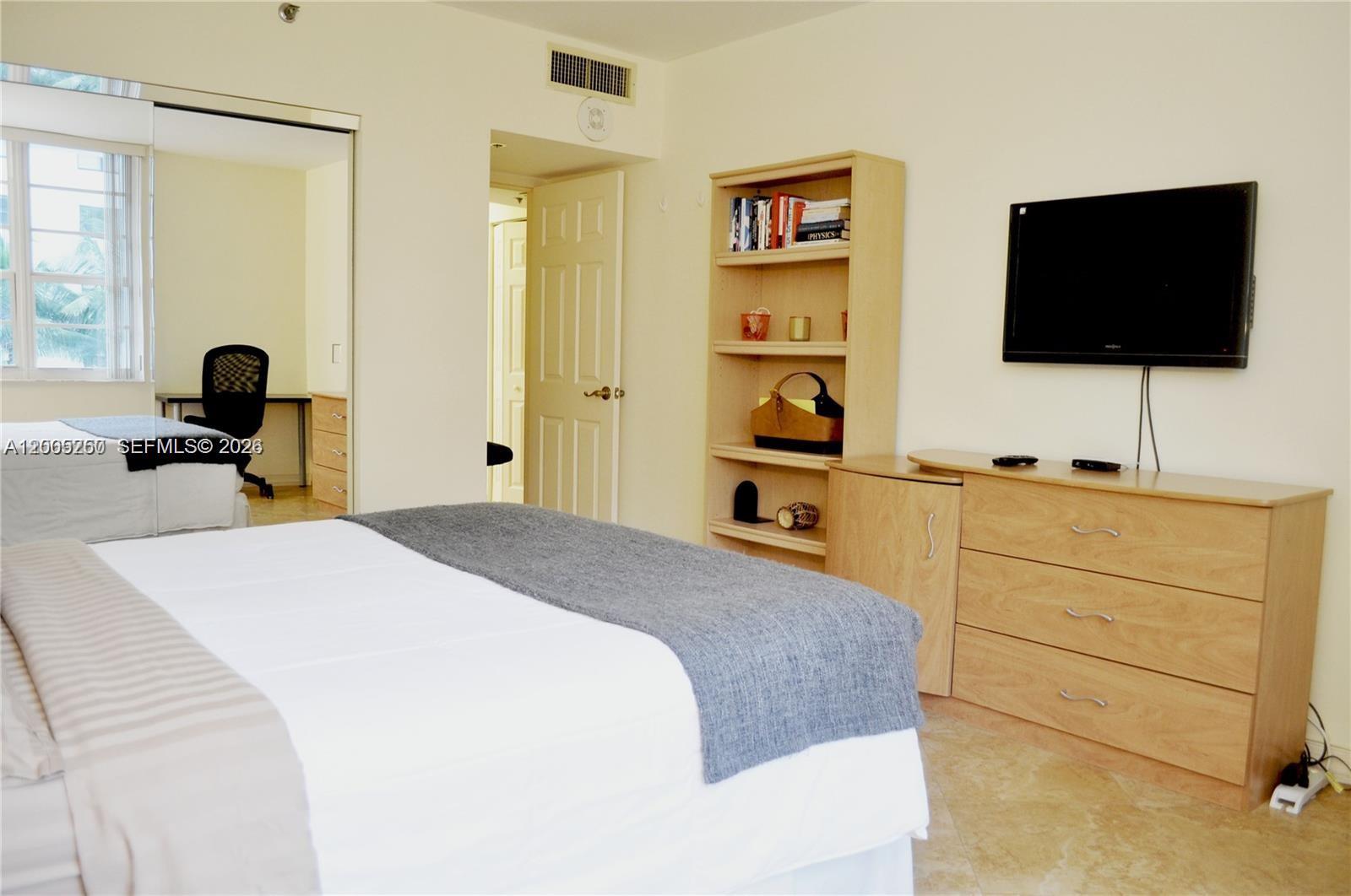 100 Lincoln Road, Unit 534 Miami Beach, FL 33139 - Photo 10 of 15 a bedroom with a bed and a flat screen tv