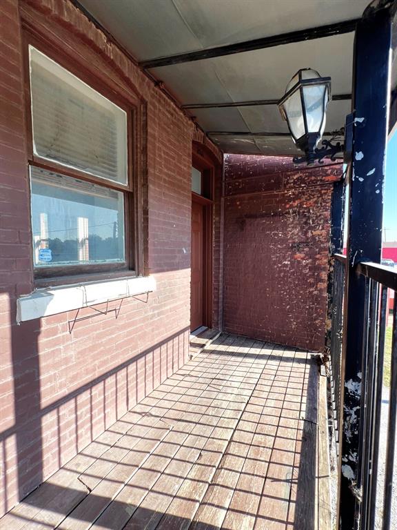 109 Northwest 20th Street, Unit 201 Fort Worth, TX 76164 - Photo 19 of 21 a view of house with wooden door