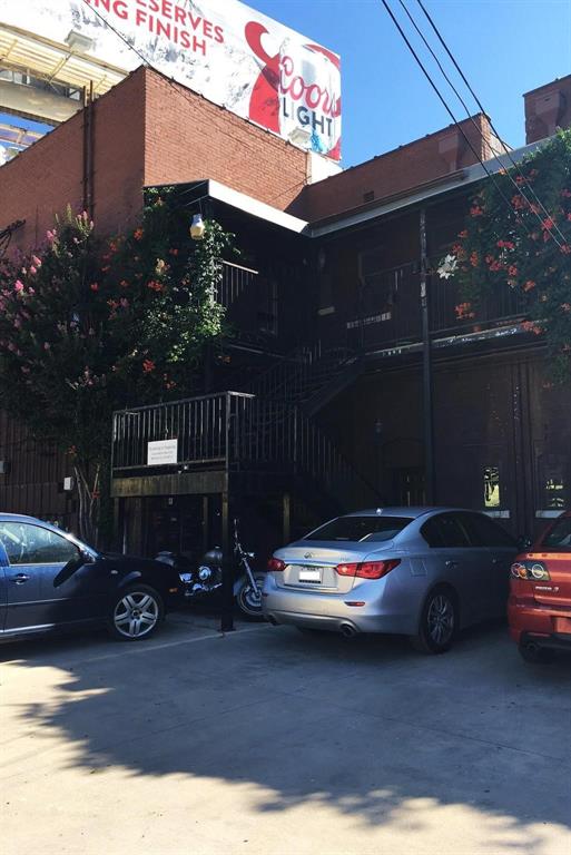 109 Northwest 20th Street, Unit 201 Fort Worth, TX 76164 - Photo 21 of 21 a car parked in front of a house