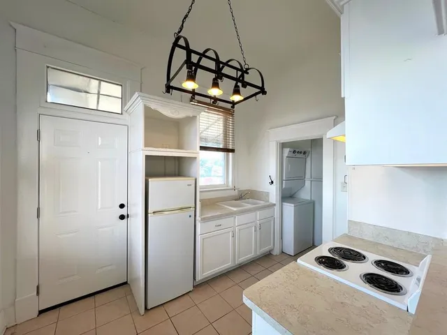 a kitchen with stainless steel appliances granite countertop a sink a refrigerator and a stove