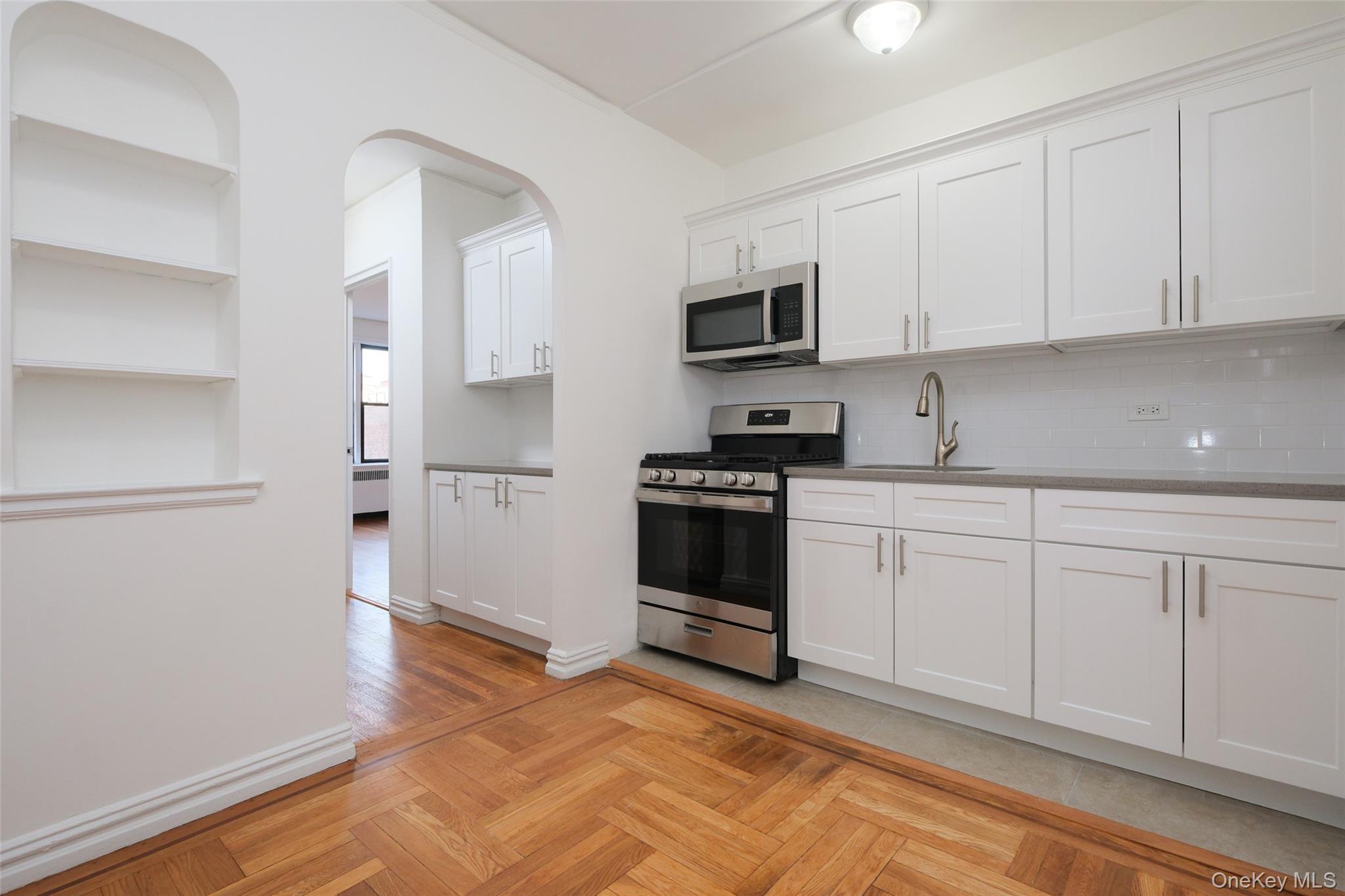 2685 Creston Avenue, Unit 5E Bronx, NY 10468 - Photo 2 of 10 a kitchen with white cabinets and white appliances