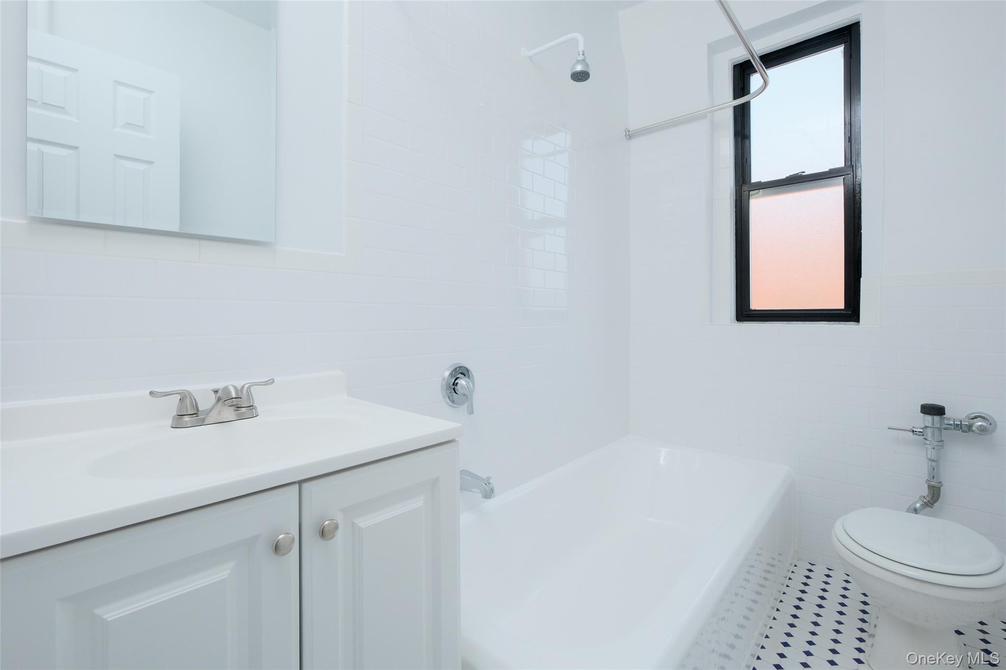 2685 Creston Avenue, Unit 5E Bronx, NY 10468 - Photo 7 of 10 a bathroom with a sink toilet and shower