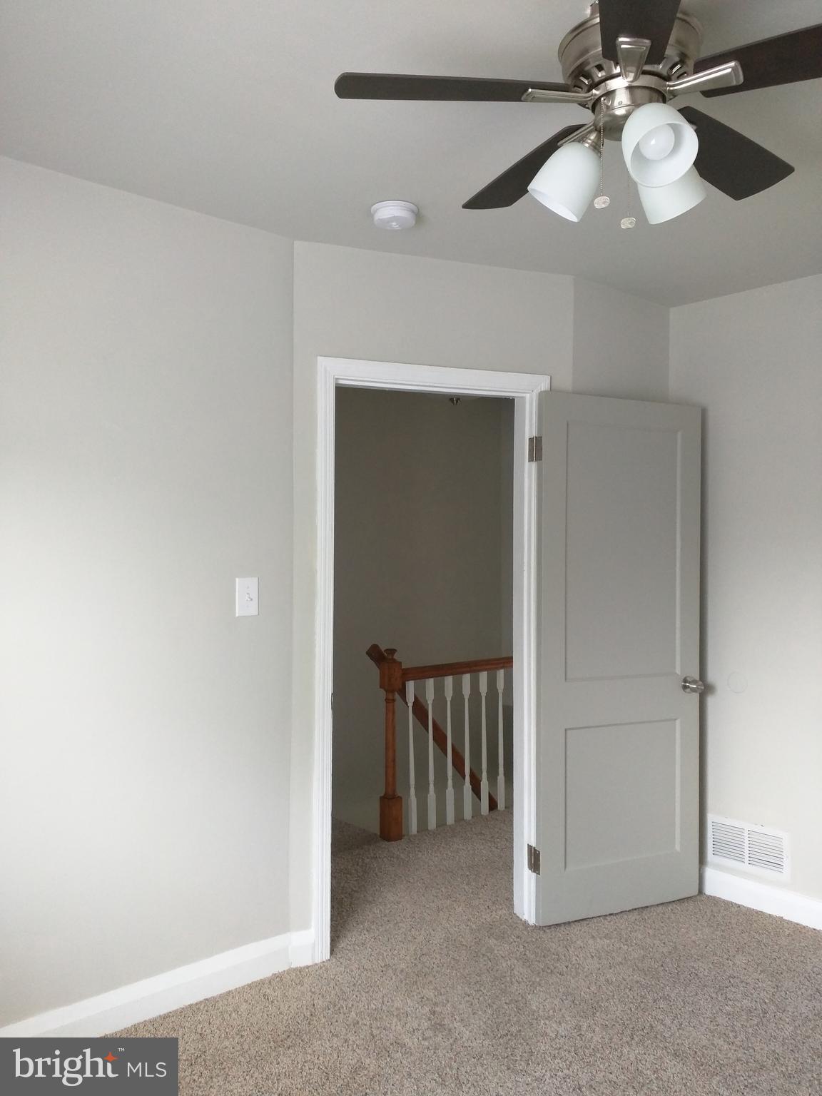 1976 Haselmere Road Dundalk, MD 21222 - Photo 17 of 28 a view of a hallway with a chandelier fan