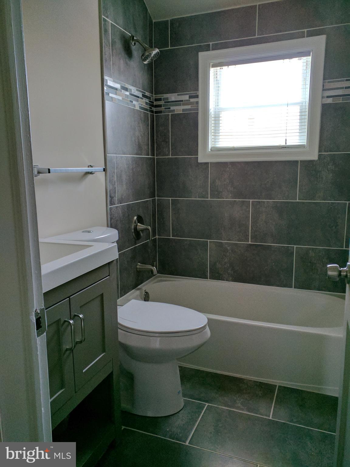 1976 Haselmere Road Dundalk, MD 21222 - Photo 22 of 28 a bathroom with a sink a toilet and shower