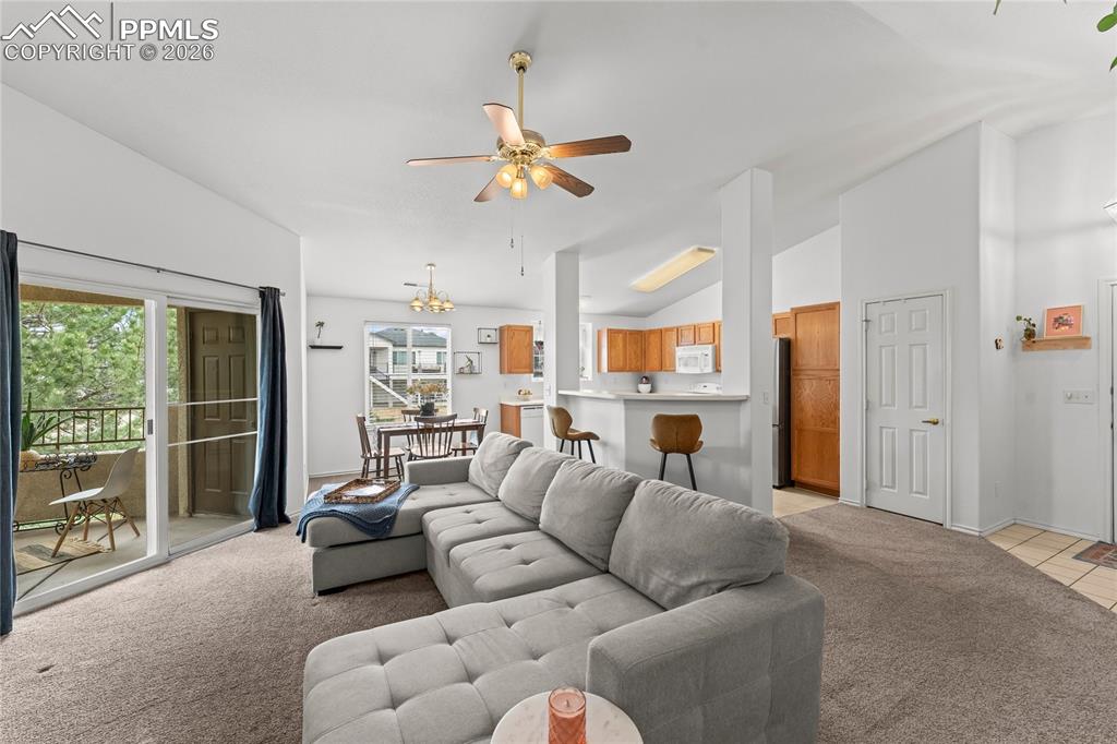 3976 Riviera Grove, Unit 203 Colorado Springs, CO 80922 - Photo 6 of 45 a living room with furniture a ceiling fan and a window