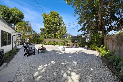 a wooden bench sitting in middle of a yard