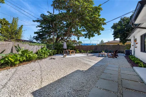 a swimming pool with outdoor seating and plants