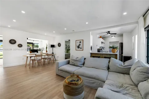 a living room with furniture and view of kitchen