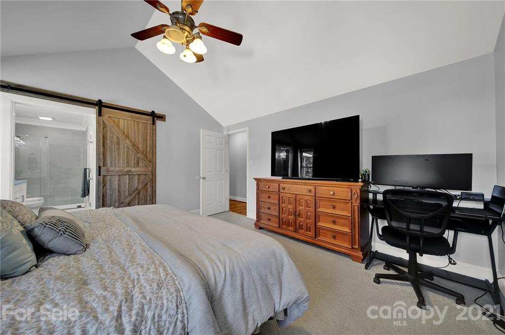 8999 West Meadow Ridge Road Indian Land, SC 29707 - Photo 13 of 28 a bedroom with a bed and a flat screen tv