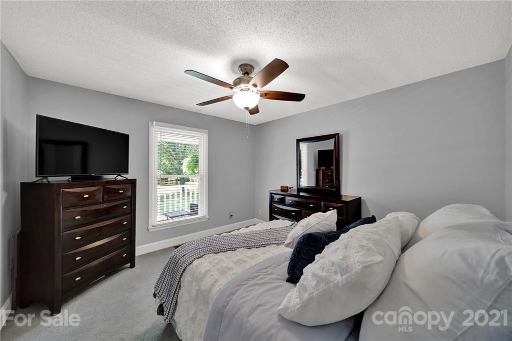 8999 West Meadow Ridge Road Indian Land, SC 29707 - Photo 15 of 28 a bedroom with a bed and a flat screen tv