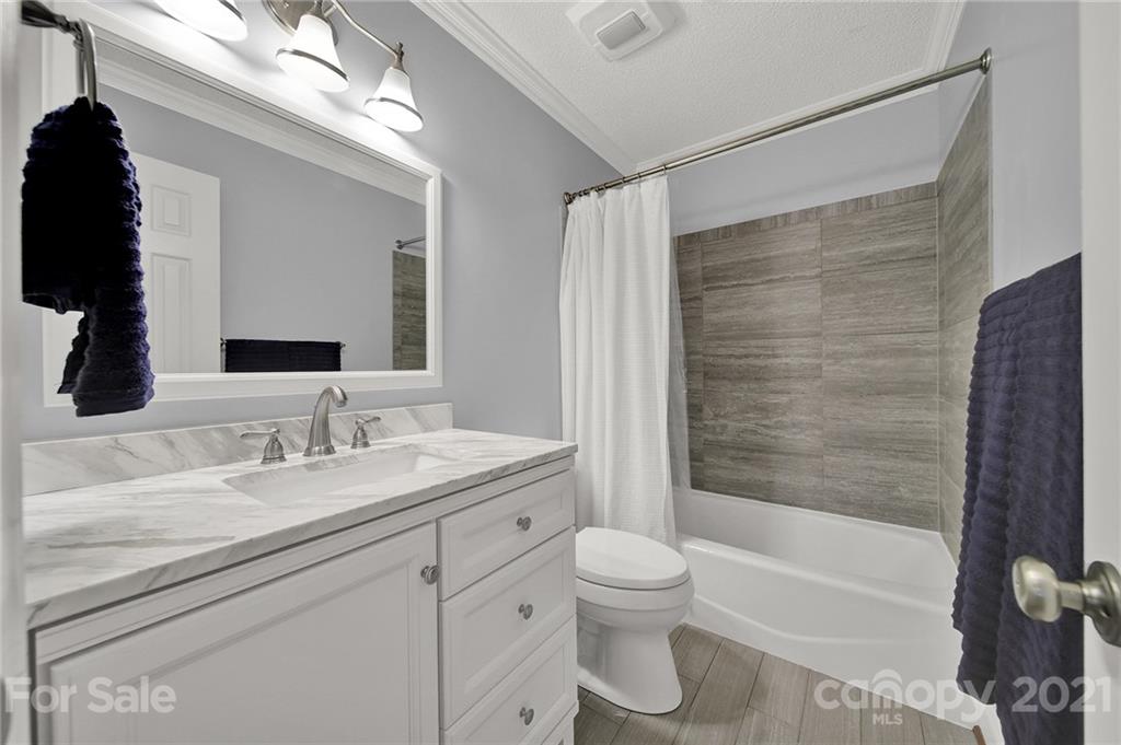 8999 West Meadow Ridge Road Indian Land, SC 29707 - Photo 16 of 28 a bathroom with a granite countertop sink toilet and shower