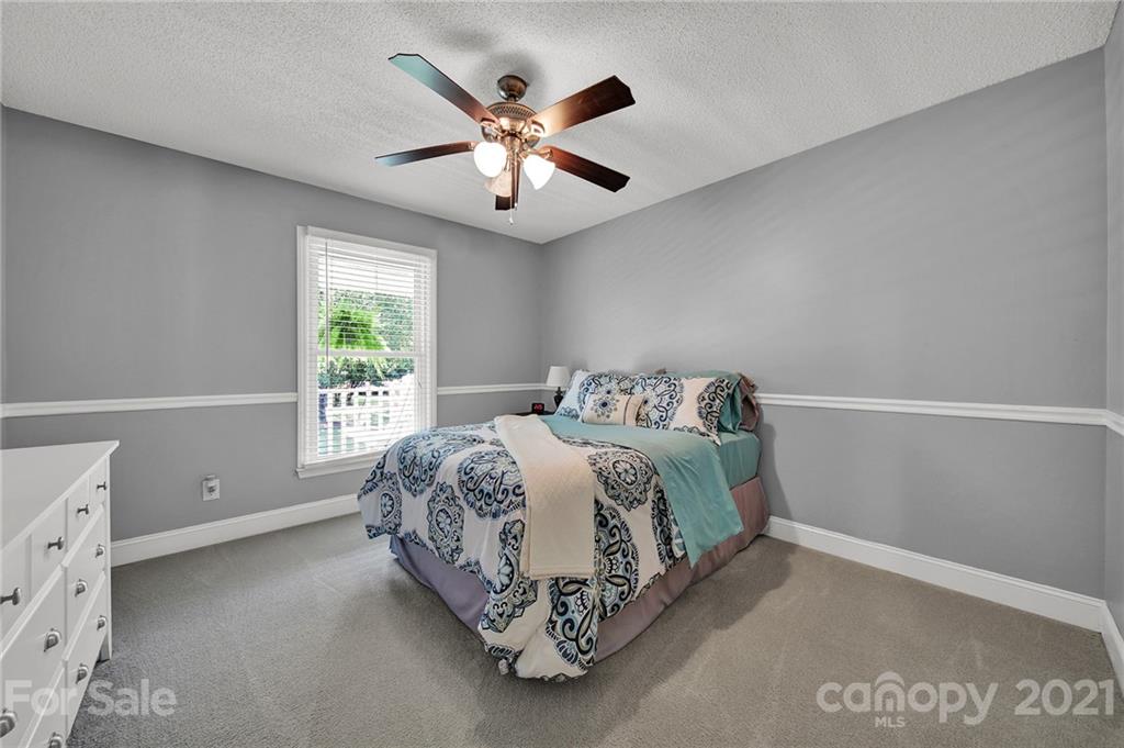 8999 West Meadow Ridge Road Indian Land, SC 29707 - Photo 17 of 28 a spacious bedroom with a bed and a window