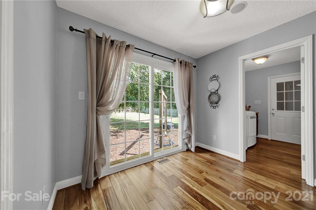 8999 West Meadow Ridge Road Indian Land, SC 29707 - Photo 18 of 28 a view of wooden floor and windows in a room