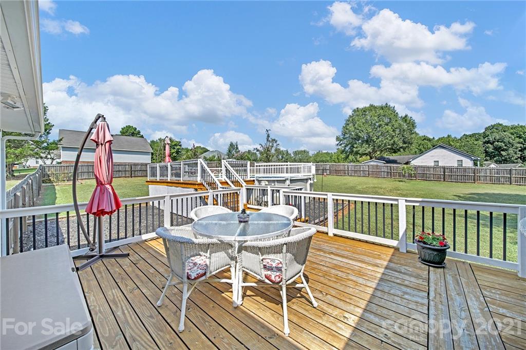 8999 West Meadow Ridge Road Indian Land, SC 29707 - Photo 3 of 28 a view of a balcony with wooden floor and outdoor seating