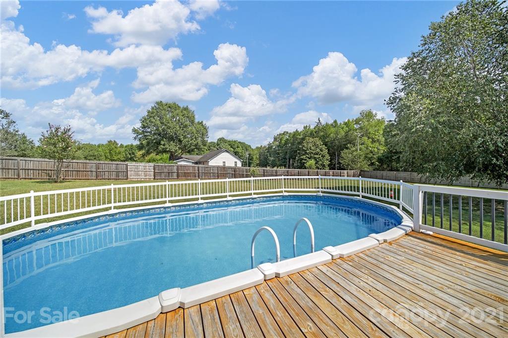 8999 West Meadow Ridge Road Indian Land, SC 29707 - Photo 4 of 28 a view of a swimming pool with a lounge chair