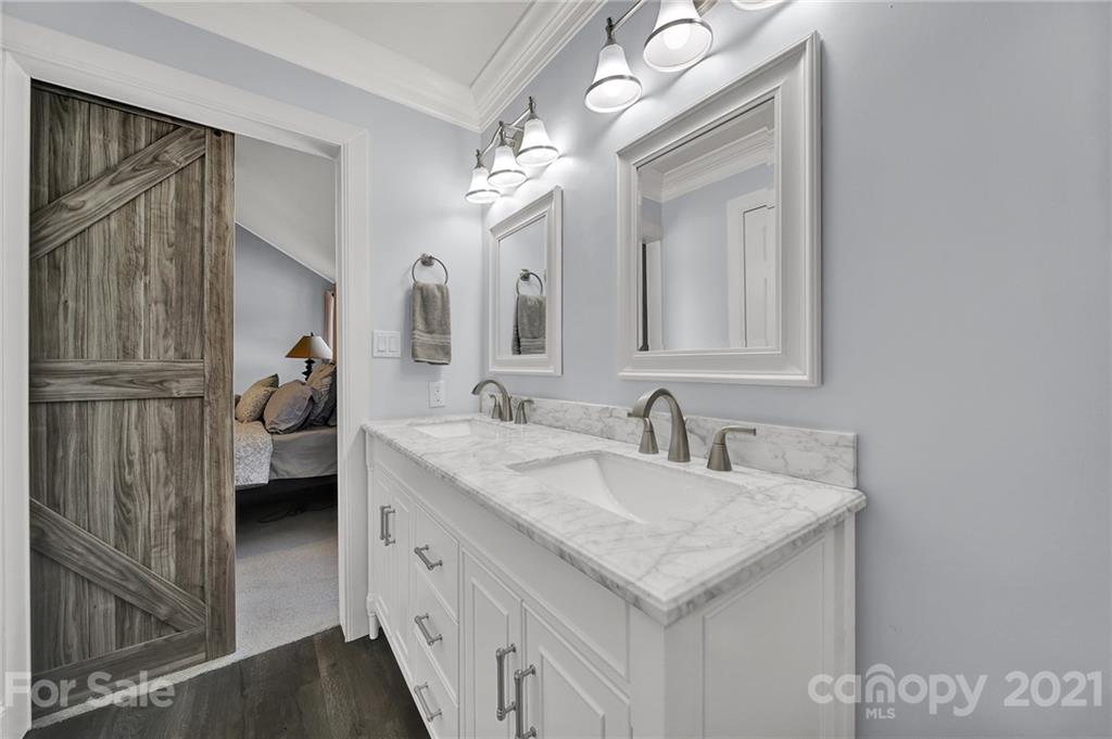 8999 West Meadow Ridge Road Indian Land, SC 29707 - Photo 10 of 28 a bathroom with a double vanity sink and a mirror