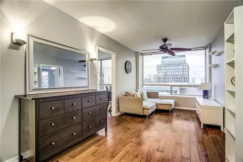 a living room with furniture and a wooden floor