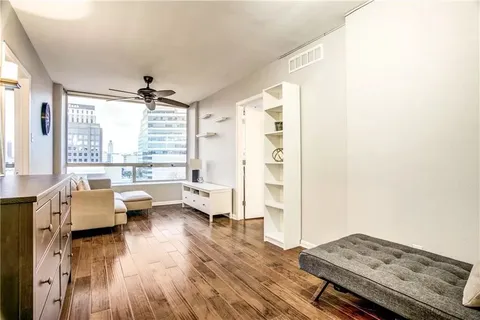 a living room with furniture and a wooden floor