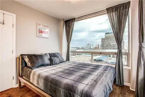 a bedroom with a large bed and a large window