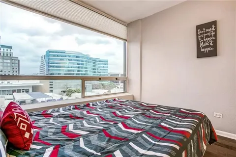 a bedroom with a bed and a chandelier