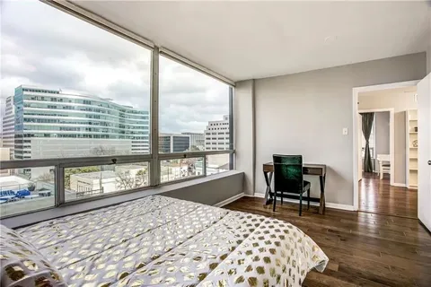 a bedroom with a large bed and a window