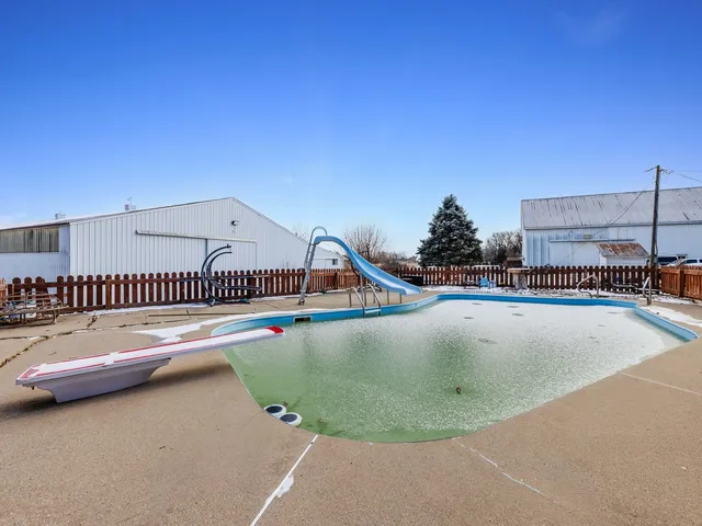 a view of roof deck with a table and chairs