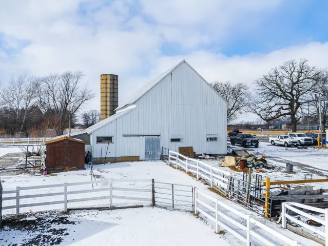 a view of a large building with wooden fence