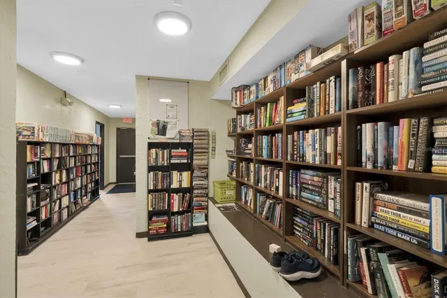 a view of a kitchen with stainless steel appliances wooden floor and a large window