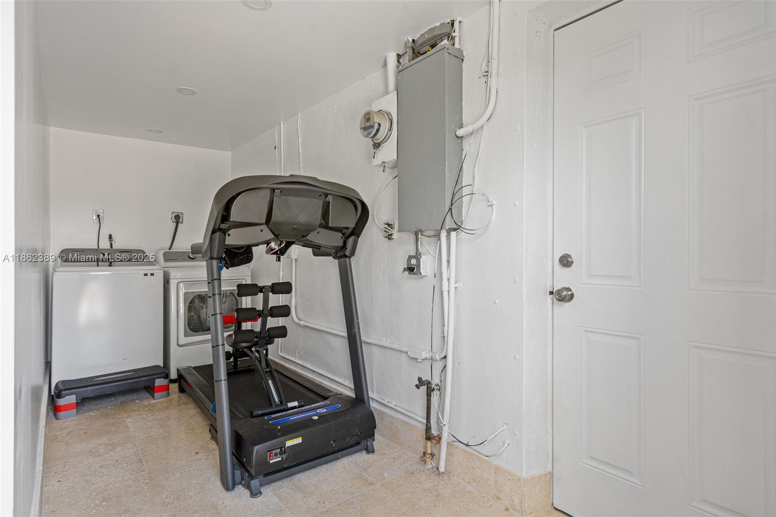6233 Rodman Street Hollywood, FL 33023 - Photo 24 of 39 a room with gym equipment and white walls