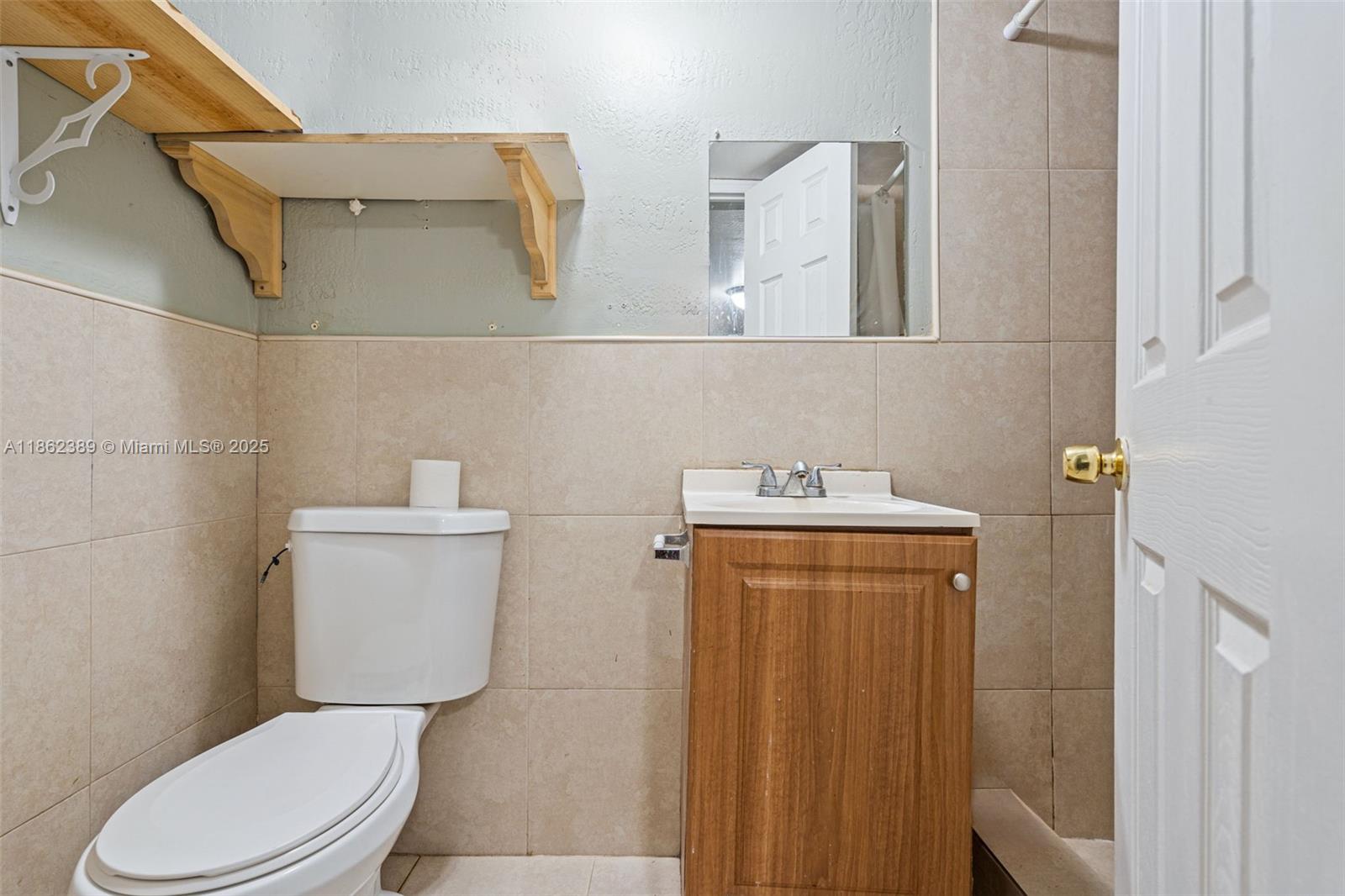 6233 Rodman Street Hollywood, FL 33023 - Photo 31 of 39 a white toilet sitting next to a bathroom sink