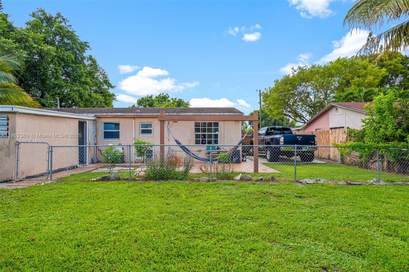 6233 Rodman Street Hollywood, FL 33023 - Photo 37 of 39 a front view of a house with a yard and porch