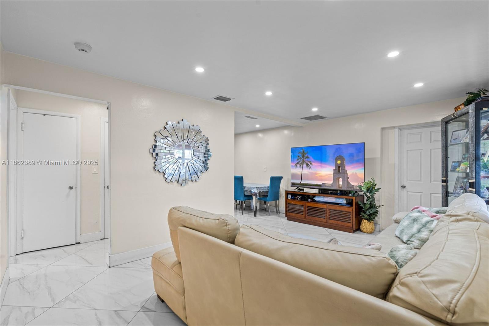 6233 Rodman Street Hollywood, FL 33023 - Photo 6 of 39 a living room with furniture and a flat screen tv