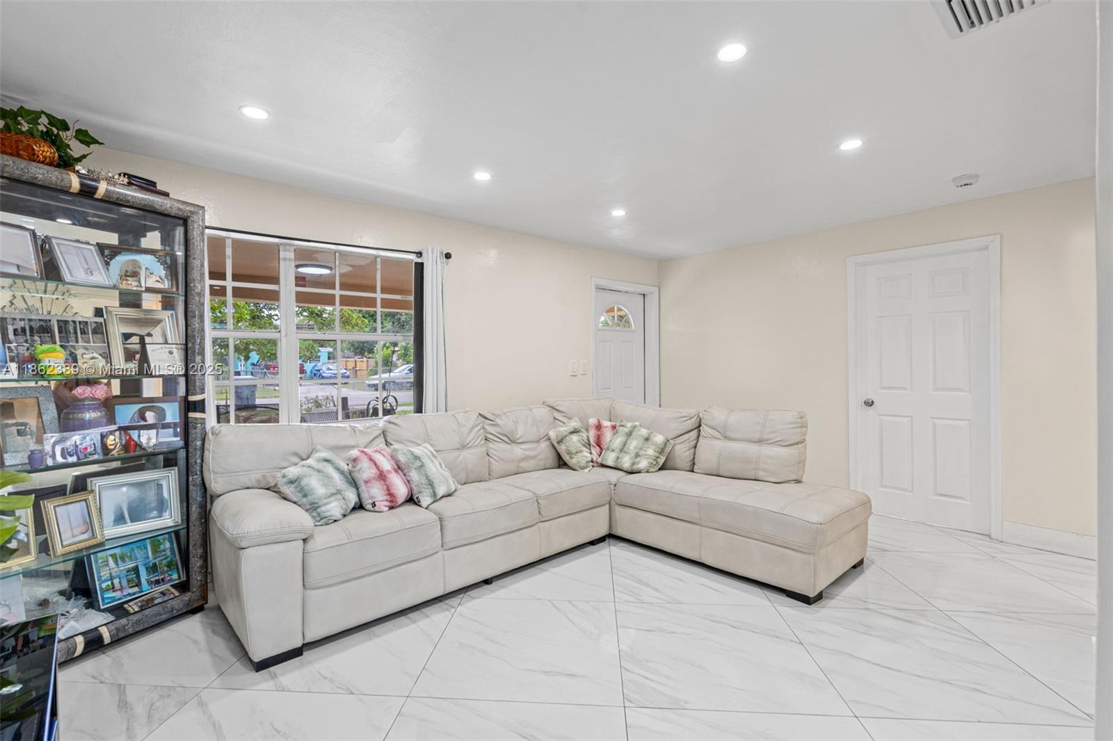 6233 Rodman Street Hollywood, FL 33023 - Photo 8 of 39 a living room with furniture and a large window