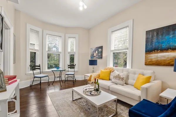 a living room with furniture and floor to ceiling windows