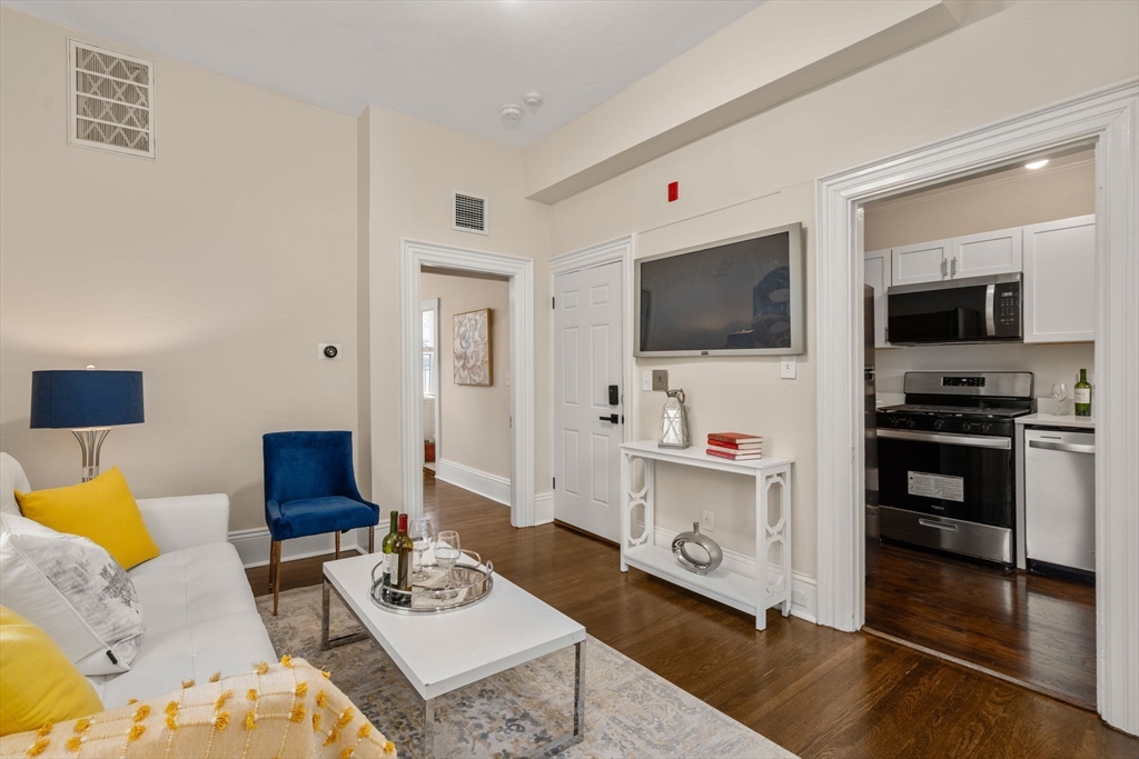 100 Magazine Street, Unit 2 Cambridge, MA 02139 - Photo 4 of 15 a living room with furniture and a flat screen tv