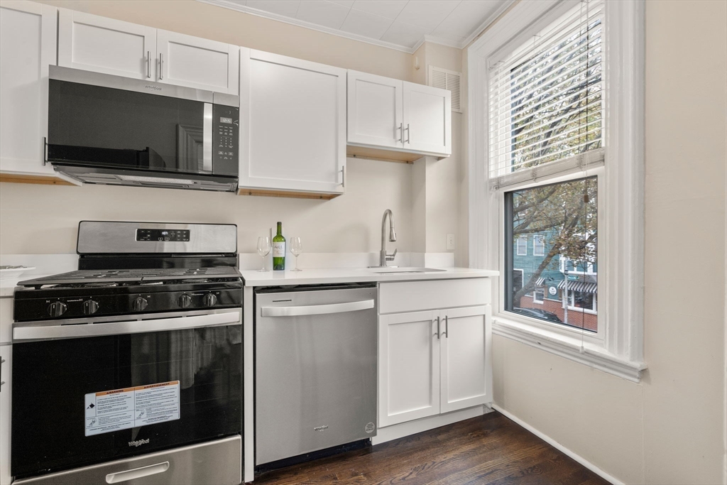 100 Magazine Street, Unit 2 Cambridge, MA 02139 - Photo 5 of 15 a kitchen with stainless steel appliances a stove a microwave and sink