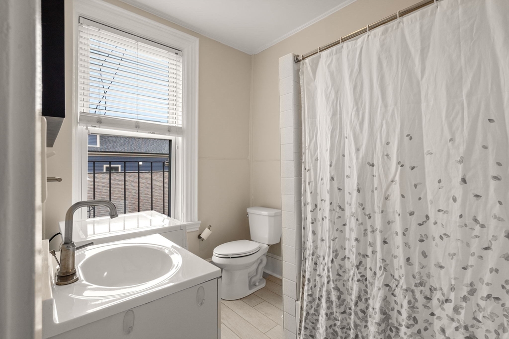 100 Magazine Street, Unit 2 Cambridge, MA 02139 - Photo 10 of 15 a bathroom with a sink a toilet and a mirror